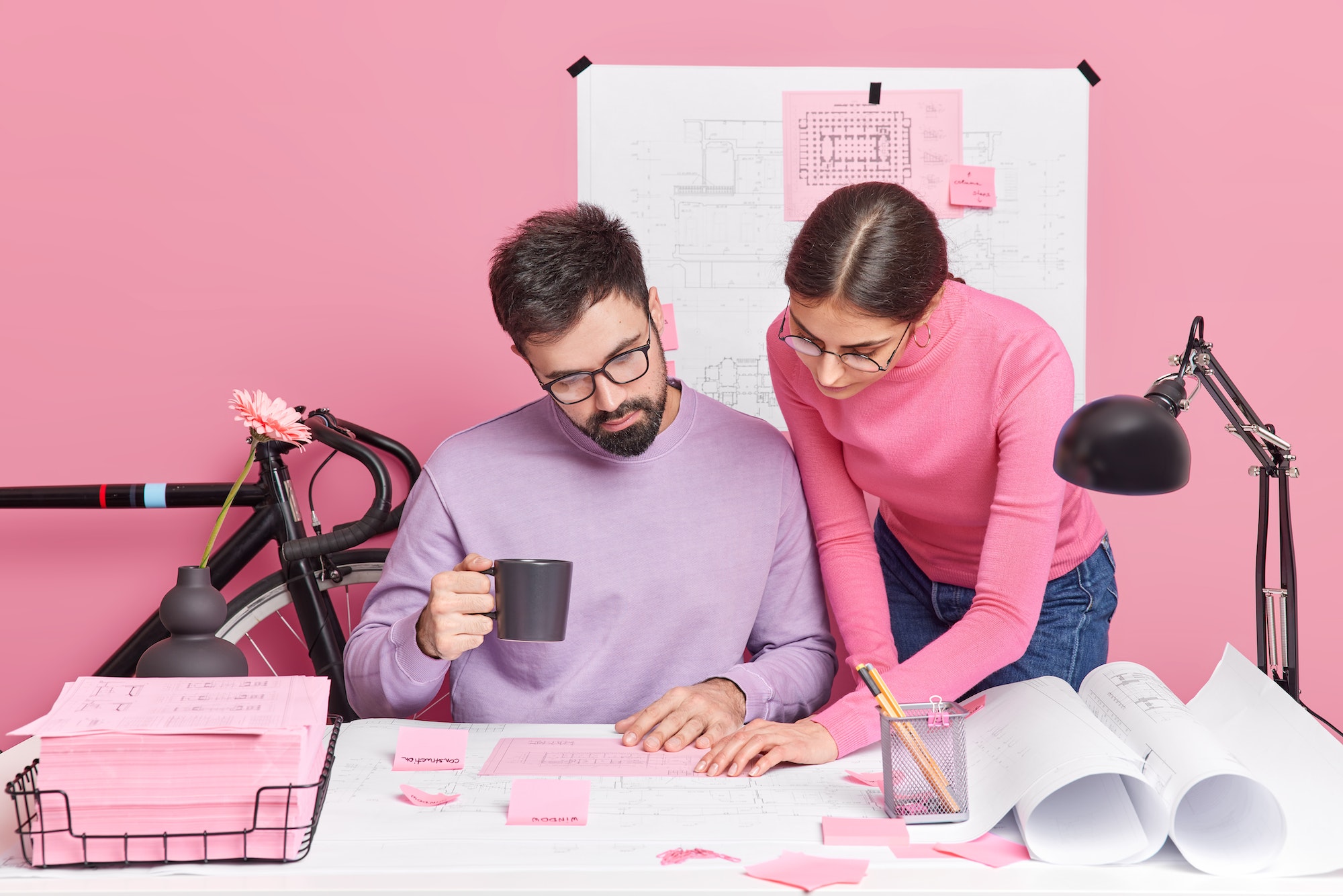 Busy woman and man office workers have brainstorming session share ideas for homework project pose i